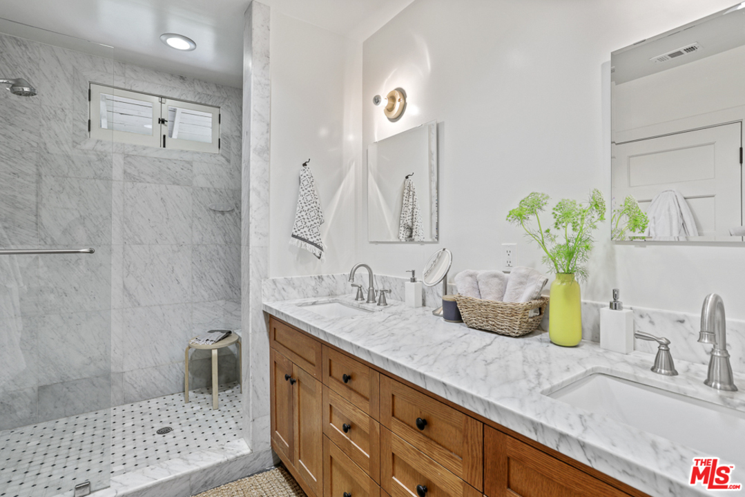 981 Worcester Avenue Pasadena, CA 91104 - Photo 17 of 24 a bathroom with a granite countertop sink a mirror and shower