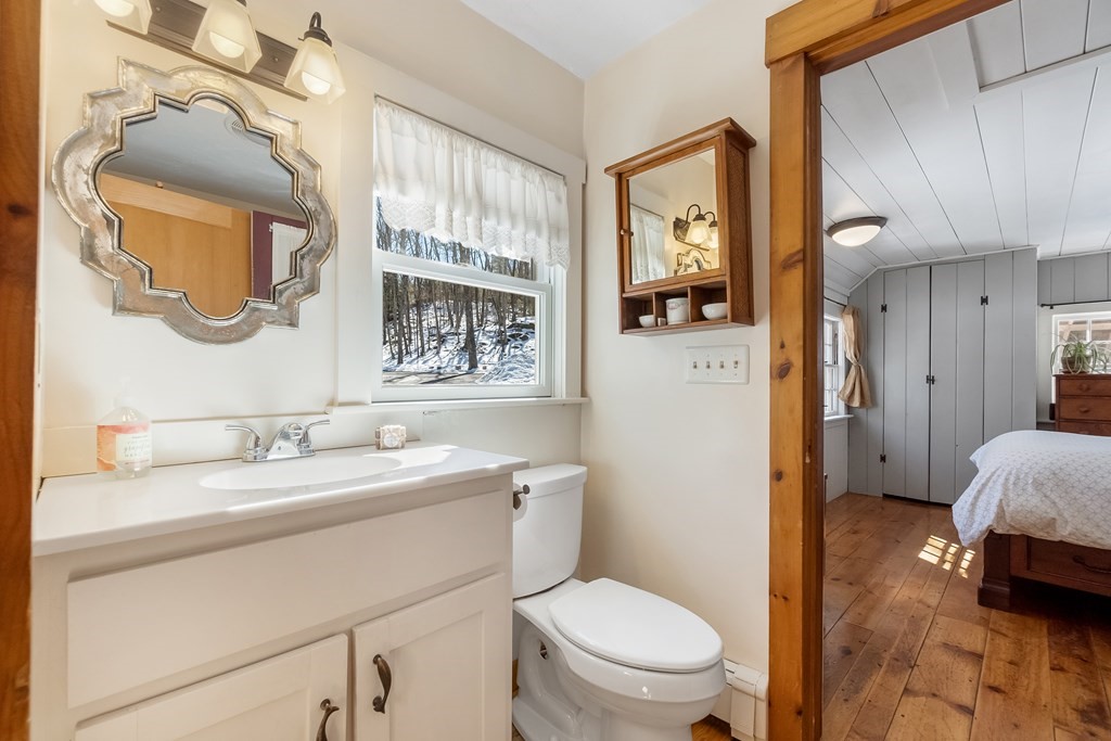 472 Sugar Road Bolton, MA 01740 - Photo 17 of 30 a en suite bathroom with a granite countertop toilet sink and mirror