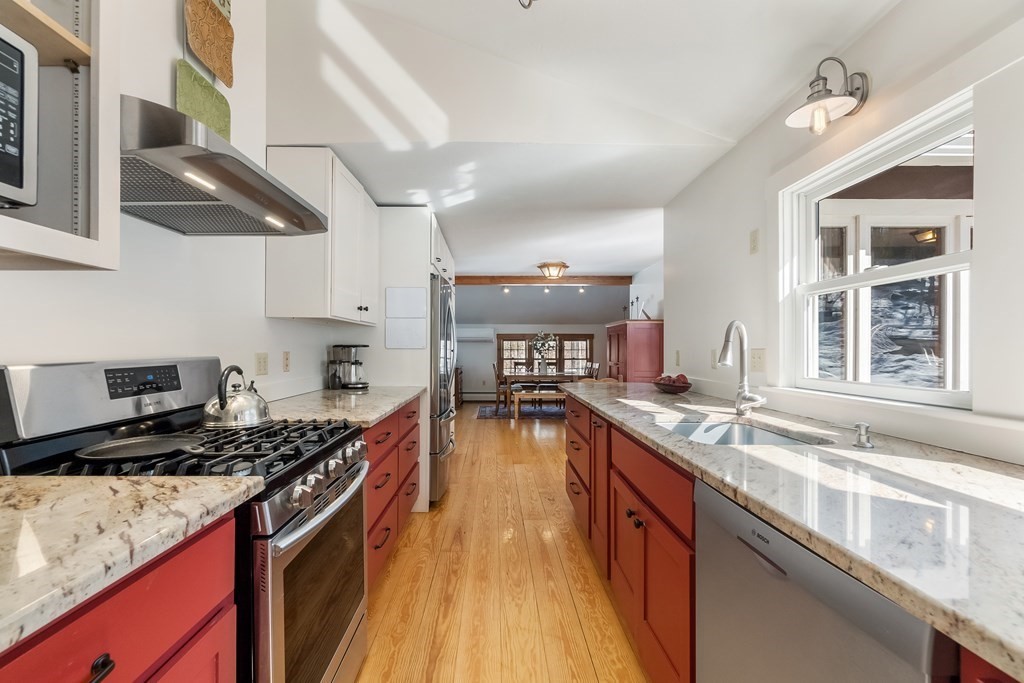 472 Sugar Road Bolton, MA 01740 - Photo 4 of 30 a kitchen with stainless steel appliances granite countertop a stove and a sink