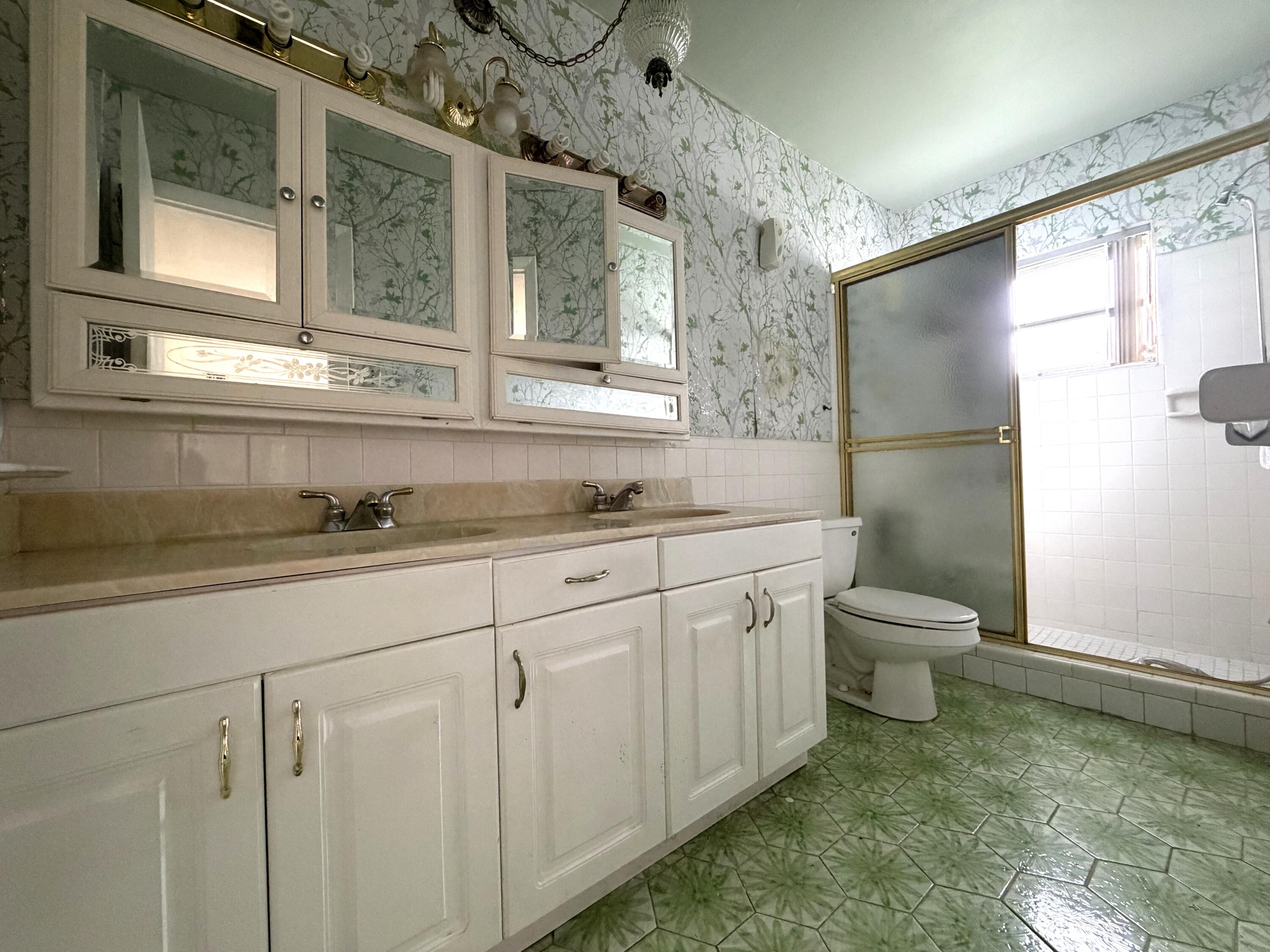 9210 Northwest 73rd Street Tamarac, FL 33321 - Photo 6 of 8 a bathroom with a granite countertop sink mirror vanity and toilet