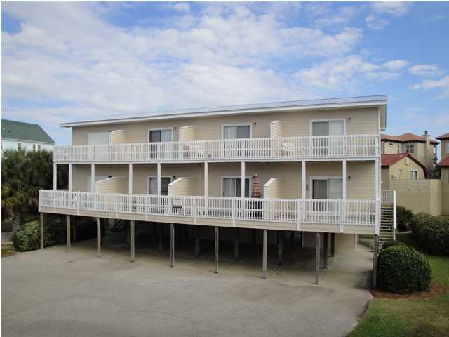 191 Blue Mountain Beach Road, Unit 303 Santa Rosa Beach, FL 32459 - Photo 1 of 20 a front view of a house with a garden and plants