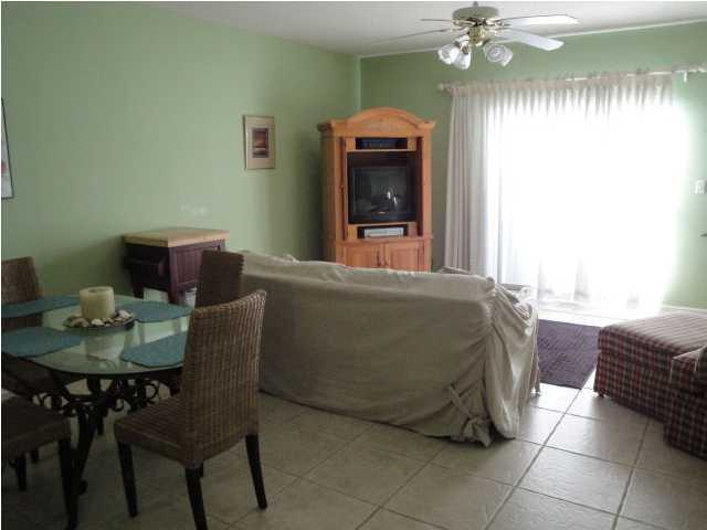 191 Blue Mountain Beach Road, Unit 303 Santa Rosa Beach, FL 32459 - Photo 4 of 20 a living room with furniture and a dining table