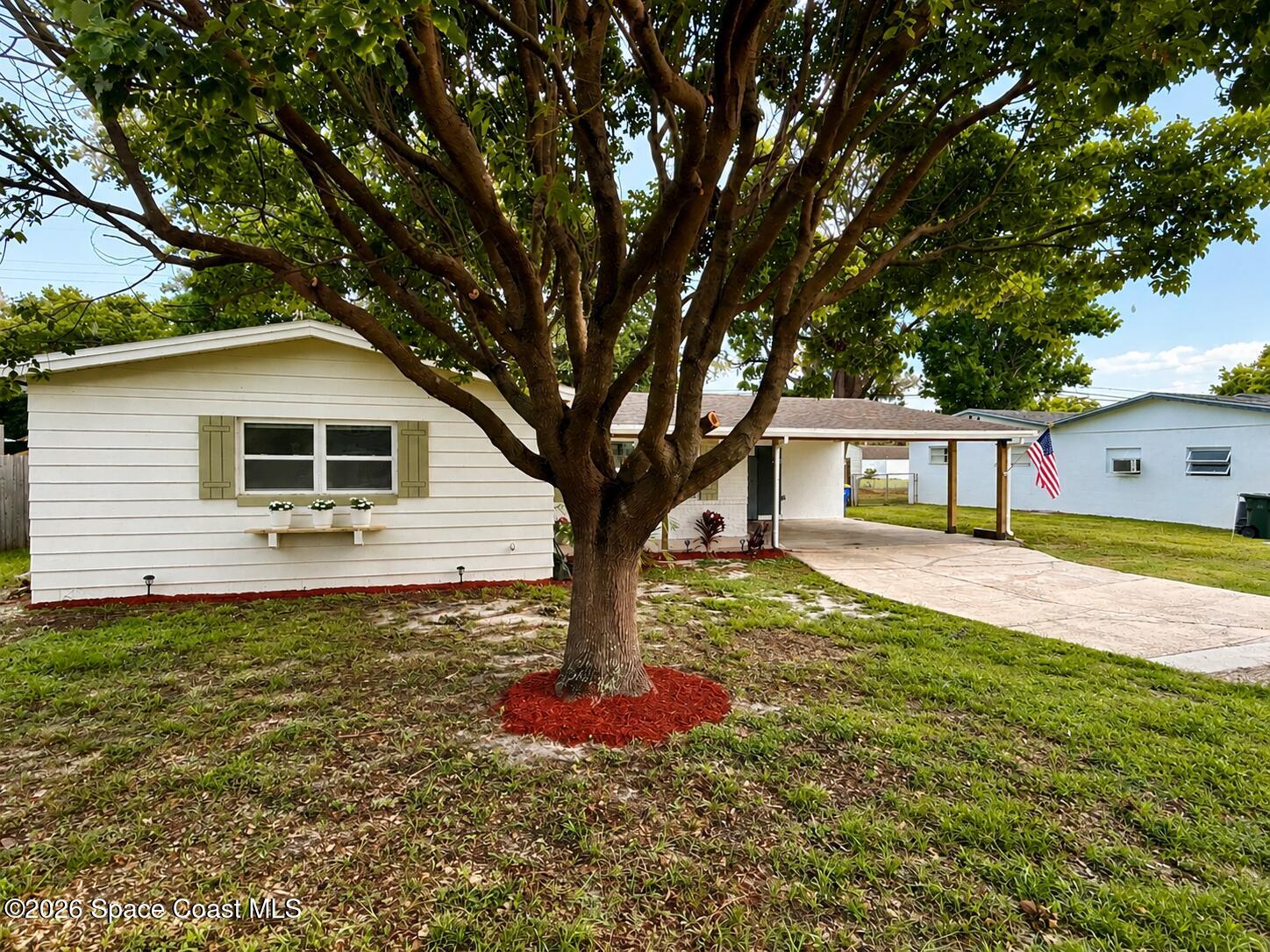 987 Kings Post Road Rockledge, FL 32955 - Photo 1 of 30 a front view of a house with a yard