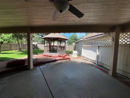 a backyard of a house with a garden and outdoor seating