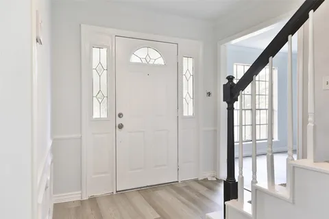 a view of an entryway with wooden floor