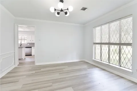 a view of a room with a window and wooden floor