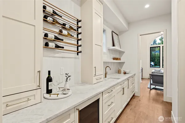 a spacious en suite bathroom with a double vanity sink and a mirror