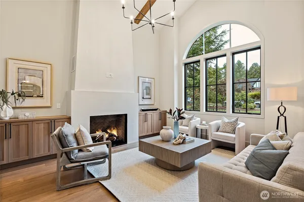 a living room with furniture a fireplace and a large window