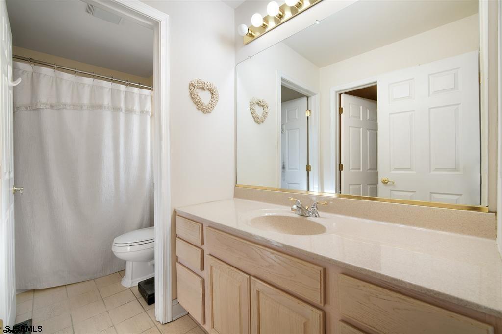 301-315 South Pitney Road Galloway Township, NJ 08205 - Photo 18 of 24 a bathroom with a sink a toilet and a mirror