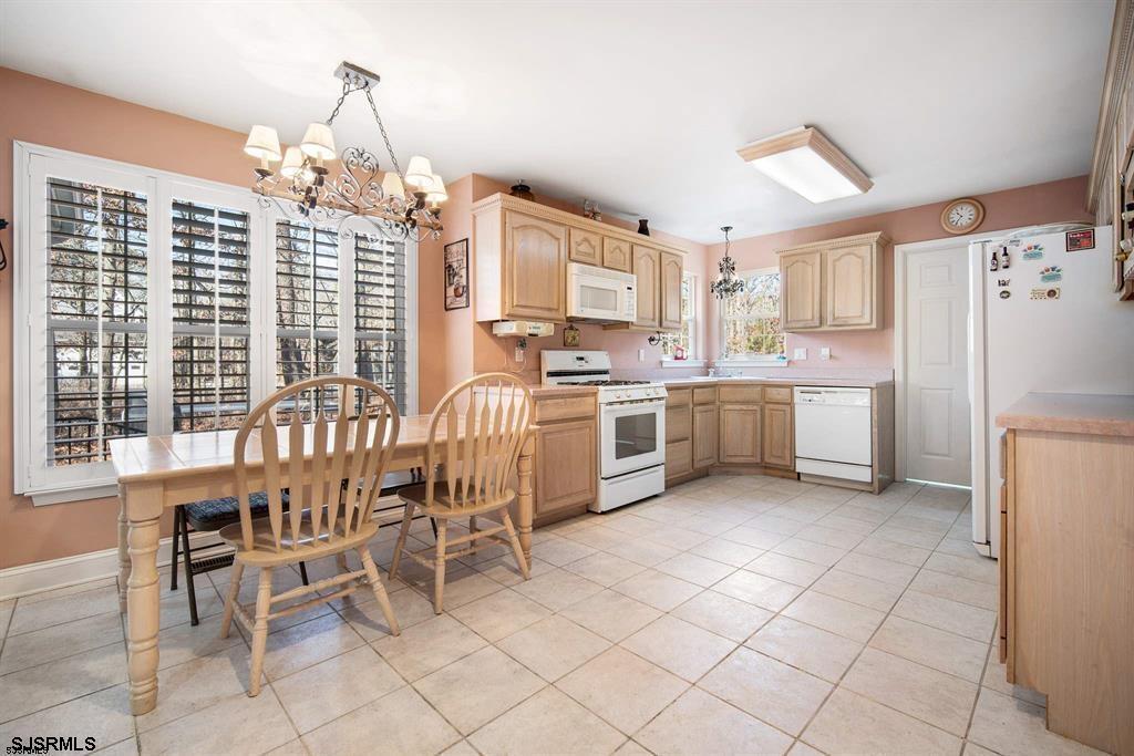 301-315 South Pitney Road Galloway Township, NJ 08205 - Photo 20 of 24 a kitchen with a table chairs and refrigerator