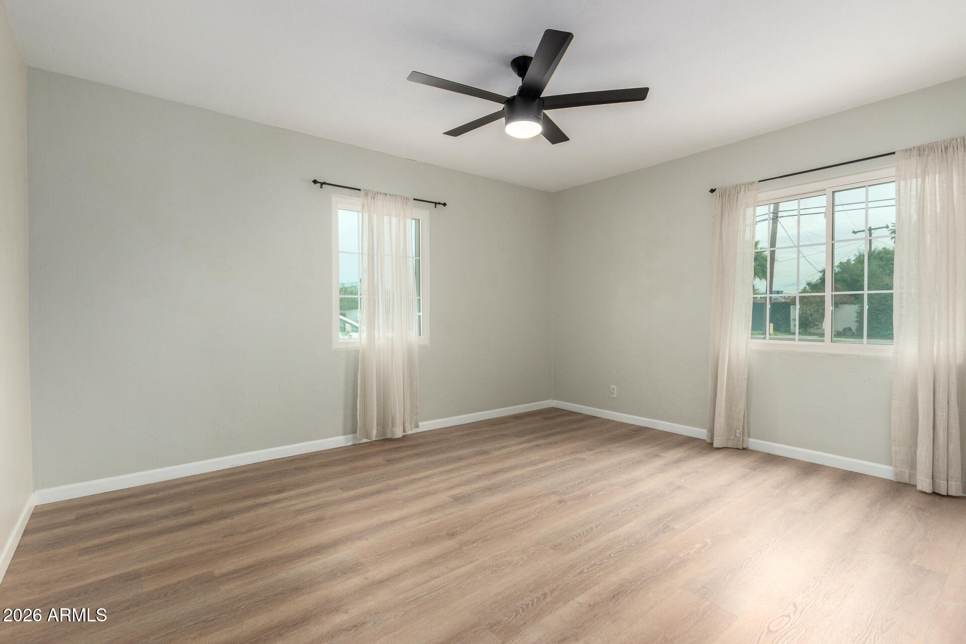 4010 North 11th Avenue Phoenix, AZ 85013 - Photo 15 of 22 wooden floor in an empty room with a window