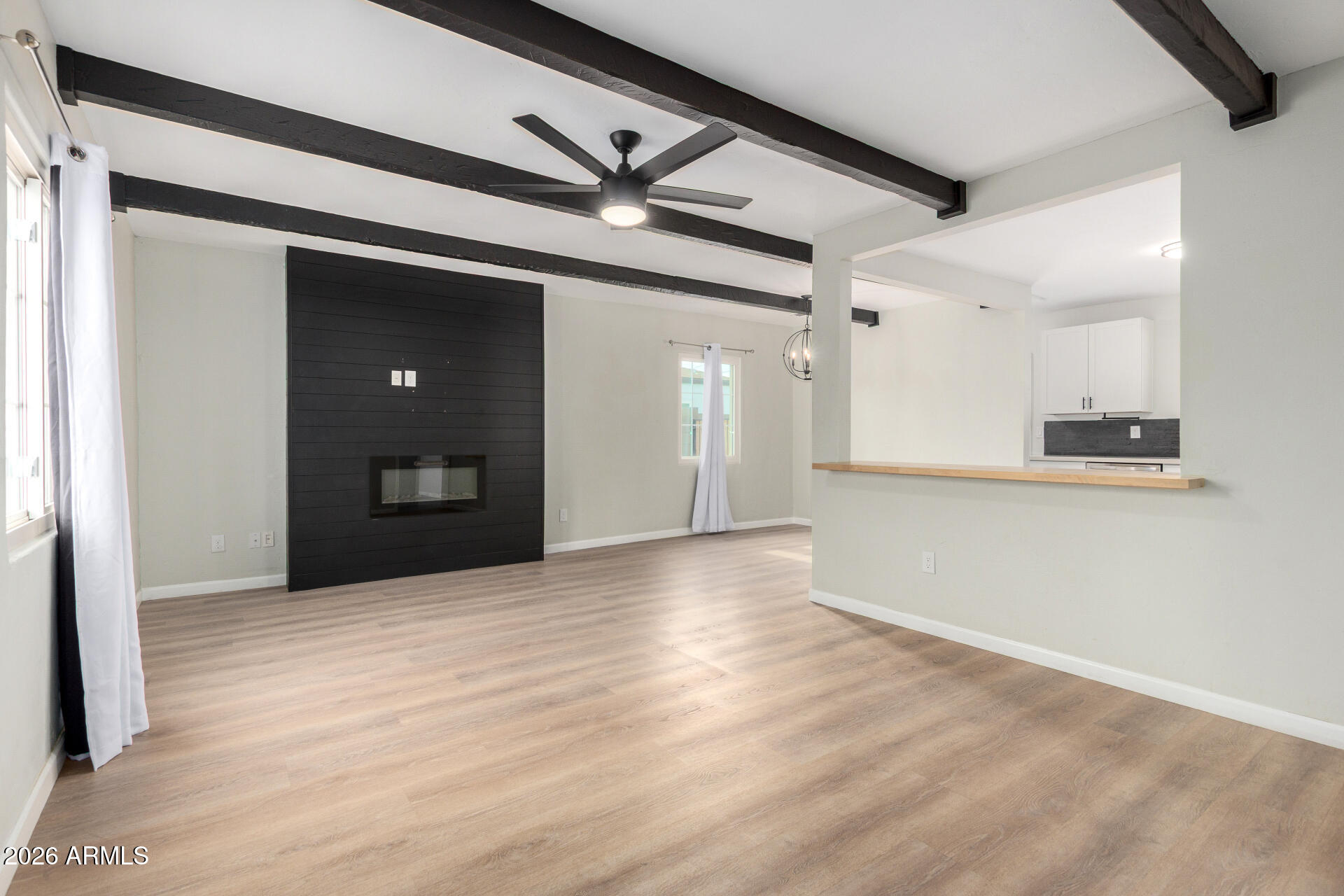 4010 North 11th Avenue Phoenix, AZ 85013 - Photo 7 of 22 a view of an empty room with wooden floor and a window