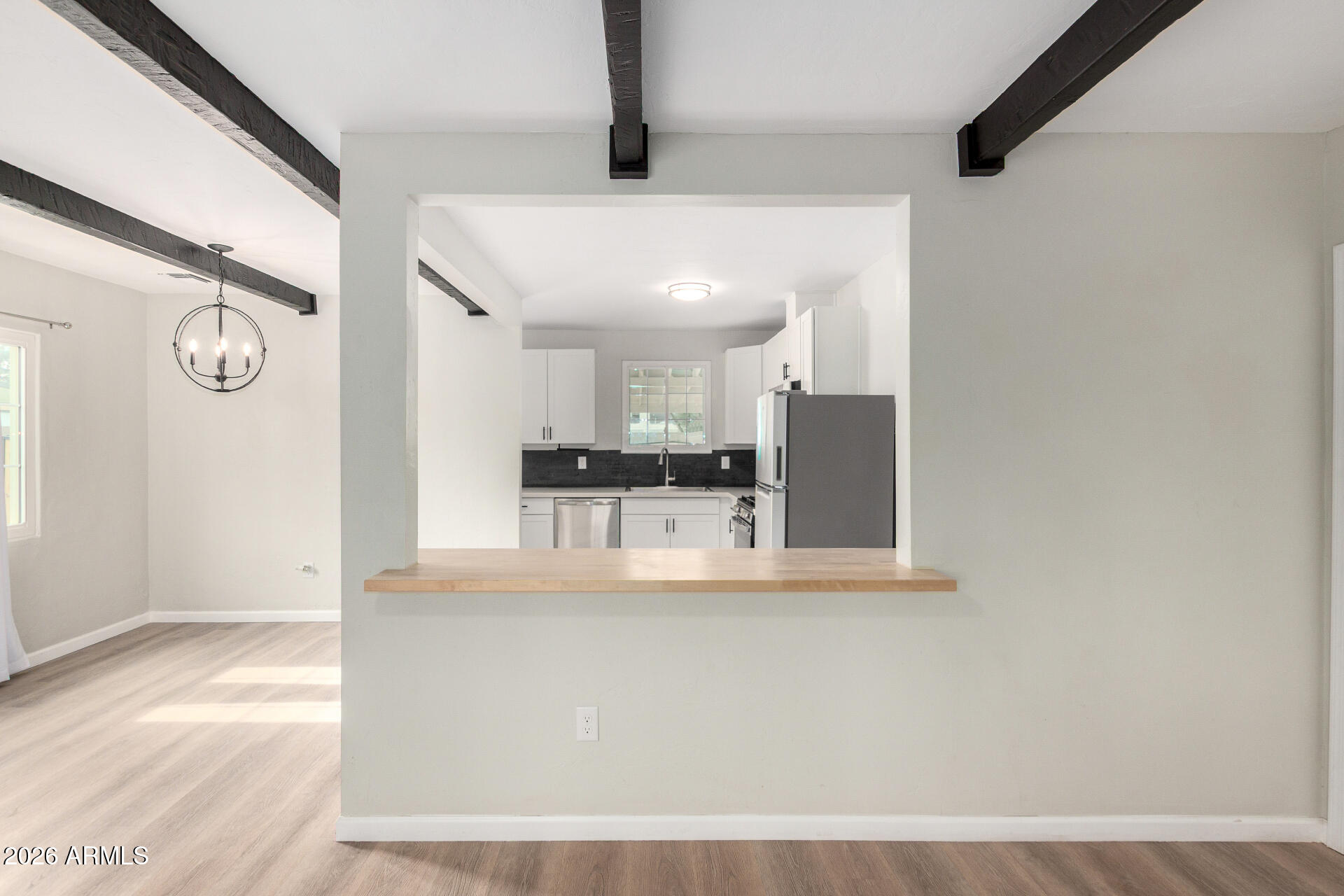 4010 North 11th Avenue Phoenix, AZ 85013 - Photo 9 of 22 a view of a kitchen with kitchen island white cabinets and stainless steel appliances