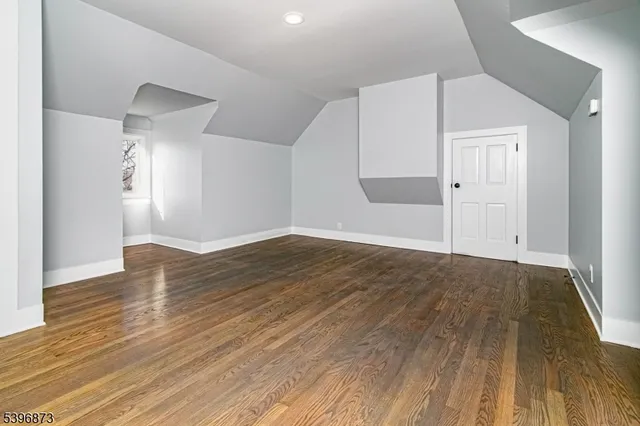 an empty room with wooden floor and closet
