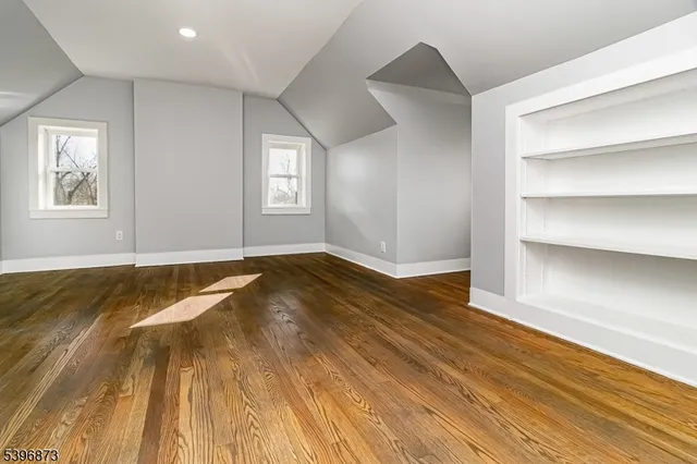 a view of a room with wooden floor and window