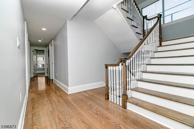 a view of entryway with wooden floor and stairs