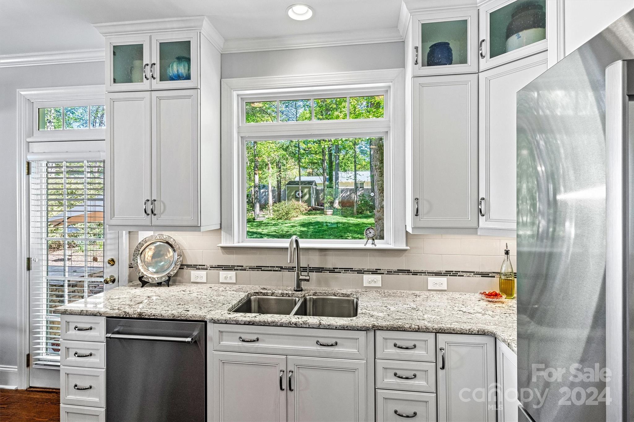 21329 Summerbrook Drive Cornelius, NC 28031 - Photo 11 of 46 a kitchen with granite countertop a sink and a window