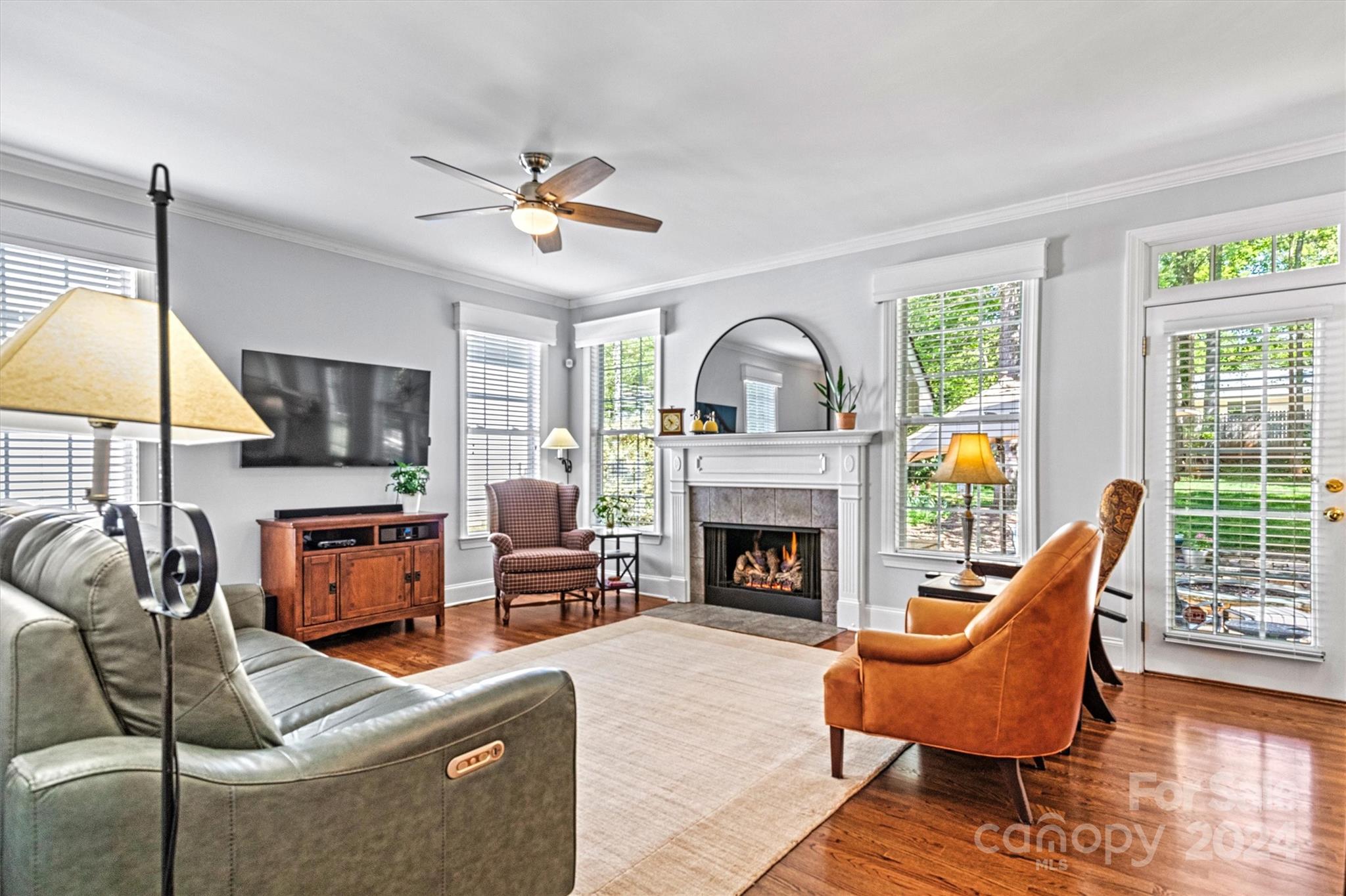 21329 Summerbrook Drive Cornelius, NC 28031 - Photo 12 of 46 a living room with furniture a fireplace and a flat screen tv