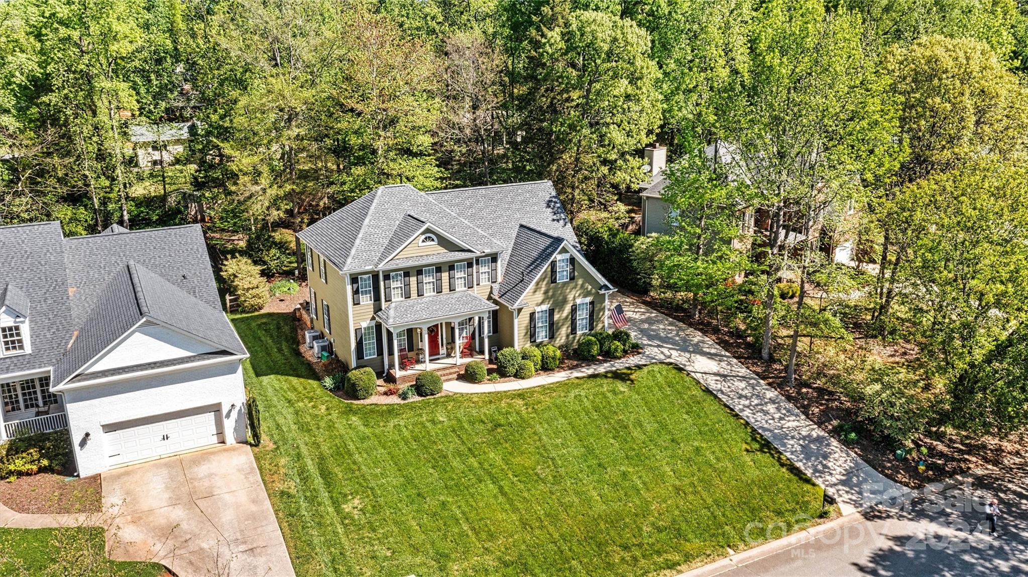21329 Summerbrook Drive Cornelius, NC 28031 - Photo 2 of 46 a view of house with a big yard and large trees