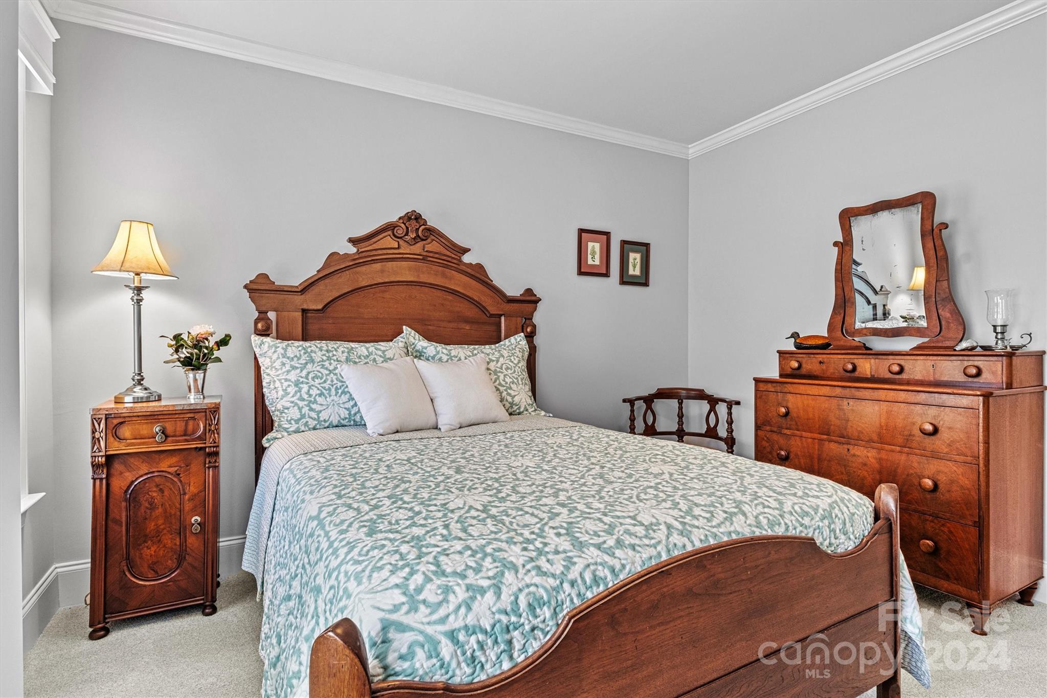 21329 Summerbrook Drive Cornelius, NC 28031 - Photo 32 of 46 a bedroom with a bed and dresser with mirror