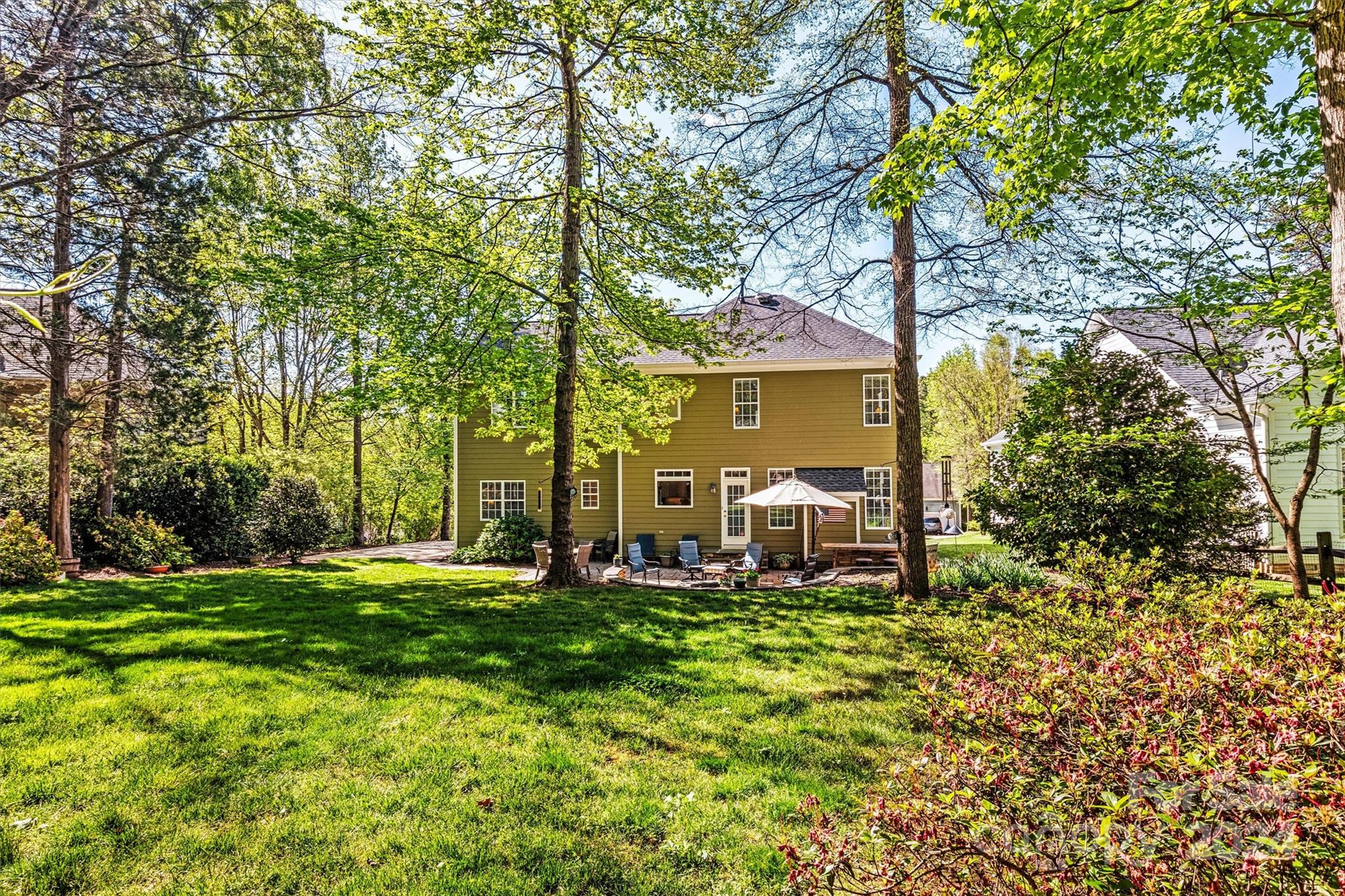 21329 Summerbrook Drive Cornelius, NC 28031 - Photo 40 of 46 a view of a house with backyard sitting area and garden