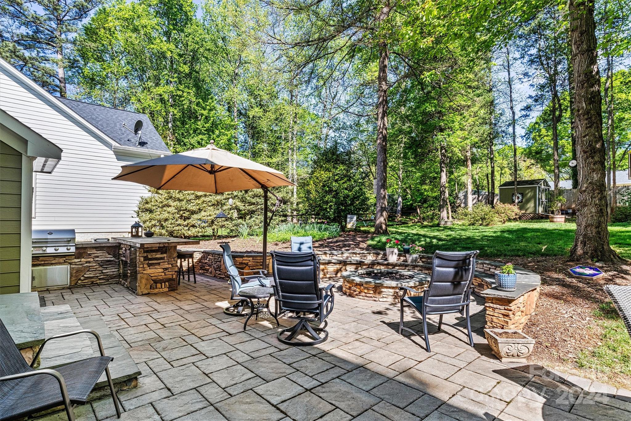21329 Summerbrook Drive Cornelius, NC 28031 - Photo 41 of 46 a view of a tables and chairs under an umbrella