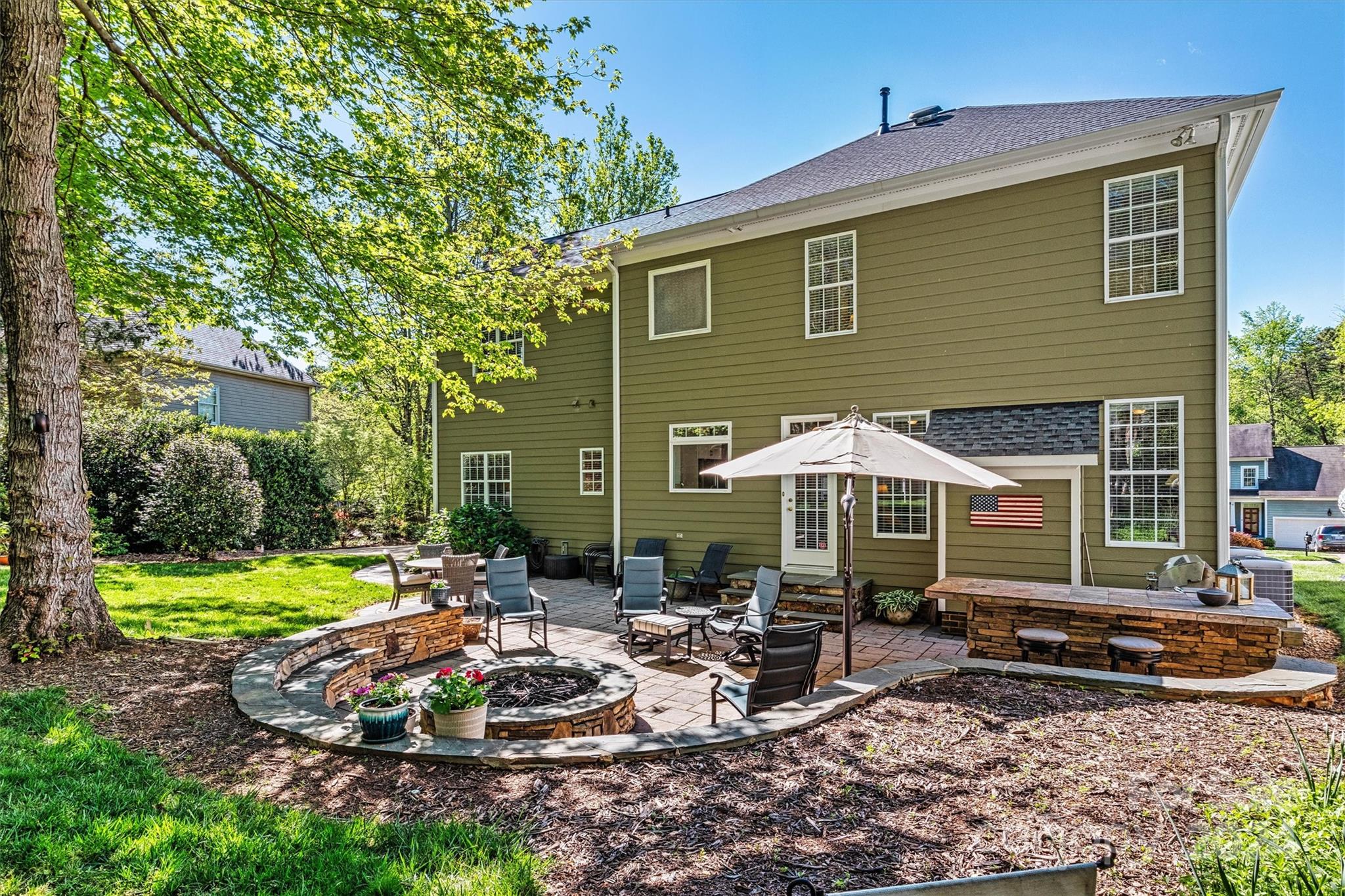 21329 Summerbrook Drive Cornelius, NC 28031 - Photo 42 of 46 a front view of a house with garden and sitting area