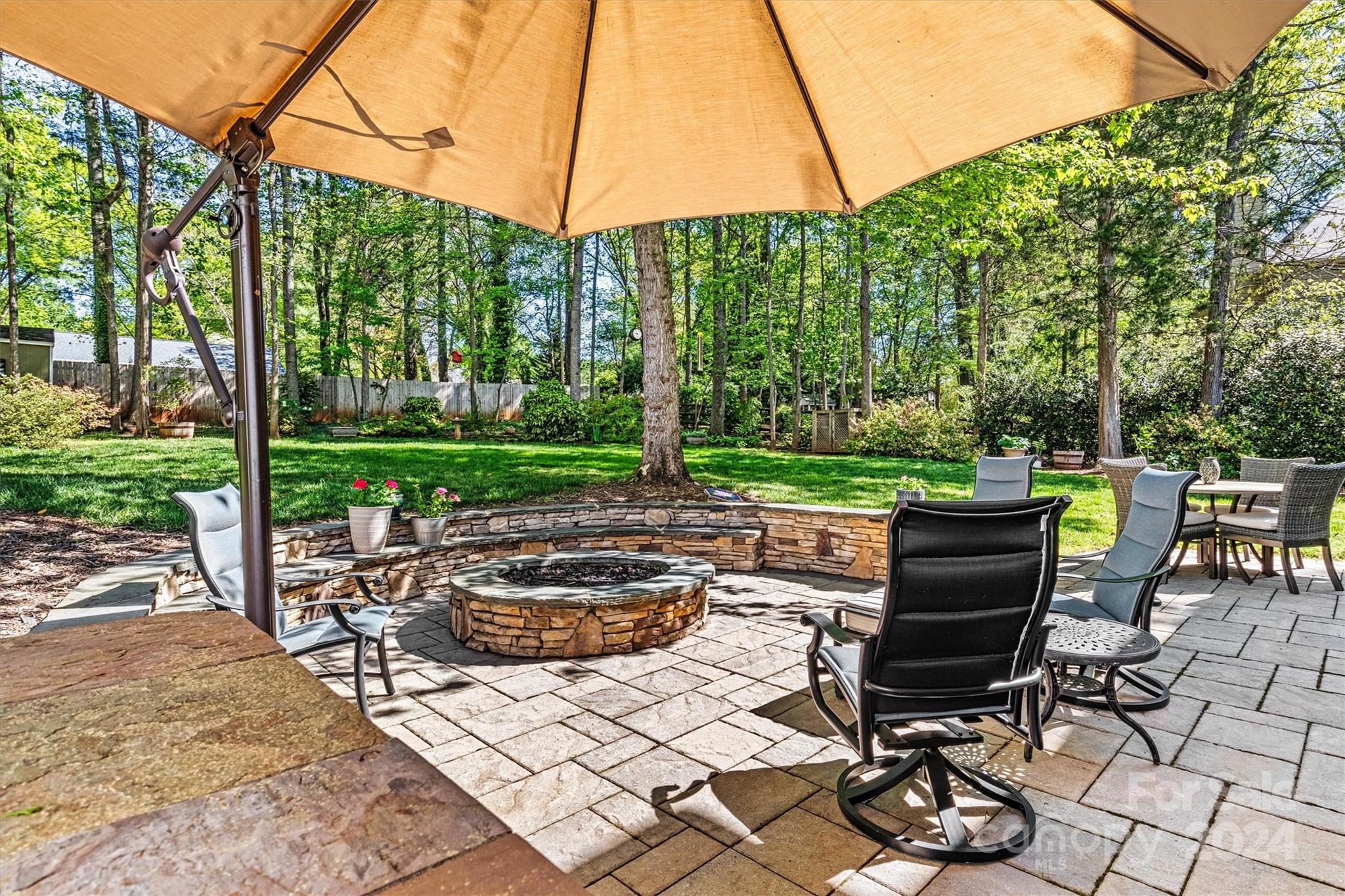 21329 Summerbrook Drive Cornelius, NC 28031 - Photo 43 of 46 a view of a patio with table and chairs potted plants and a palm tree
