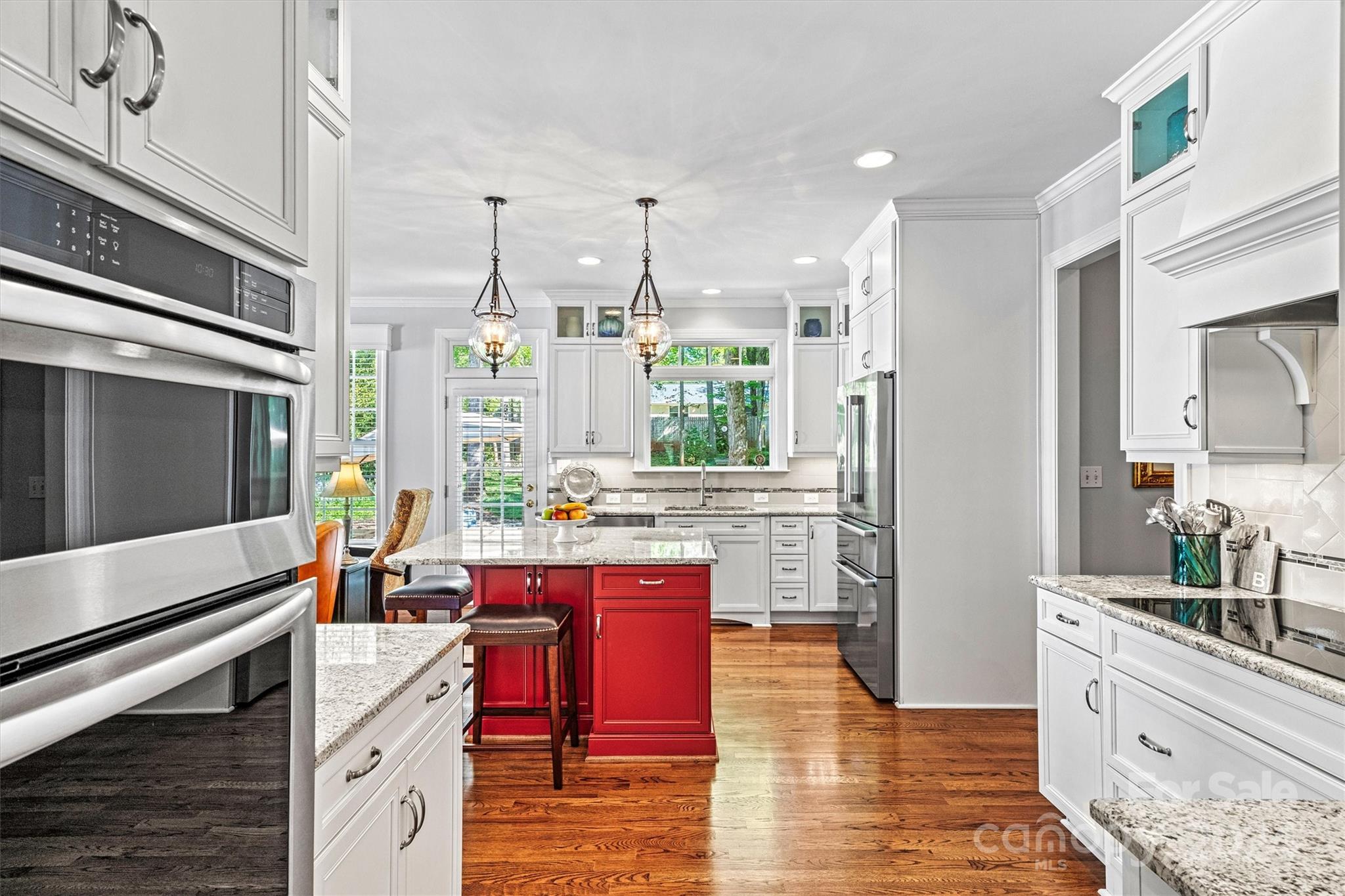 21329 Summerbrook Drive Cornelius, NC 28031 - Photo 10 of 46 a kitchen with lots of counter top space and painting on the wall