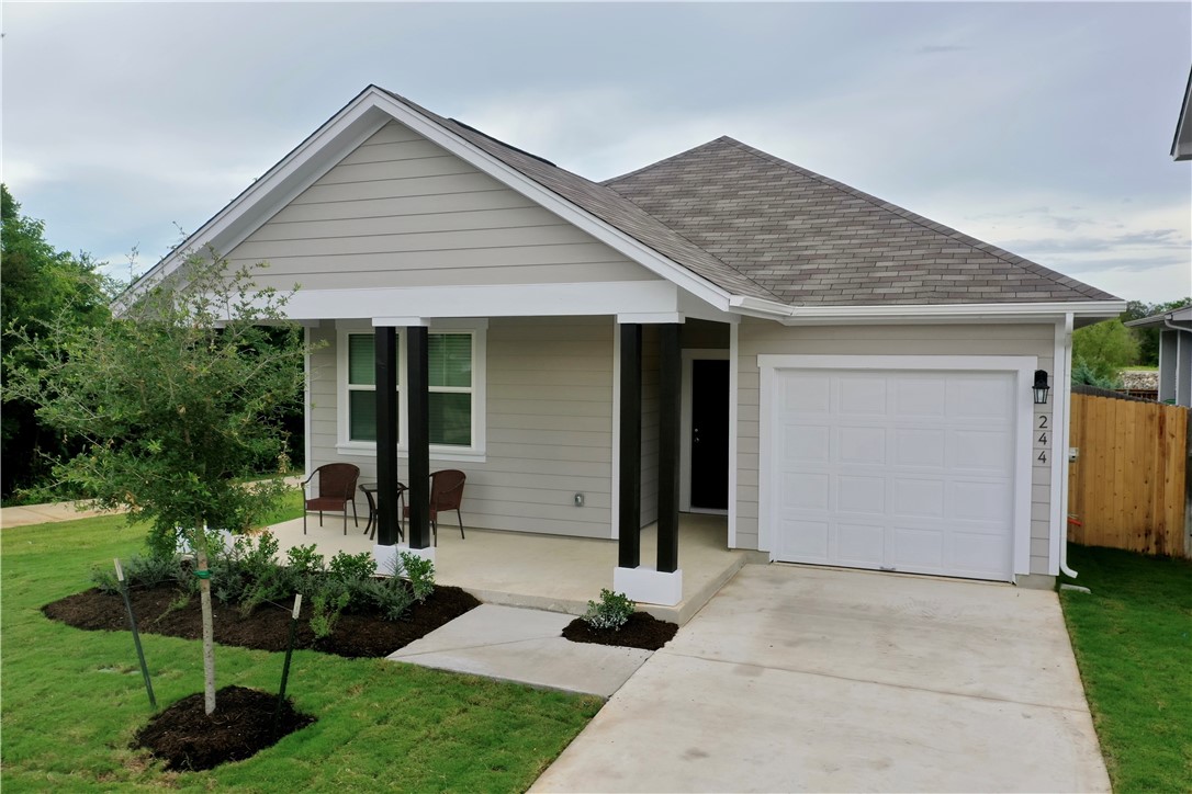 a front view of house with a garden