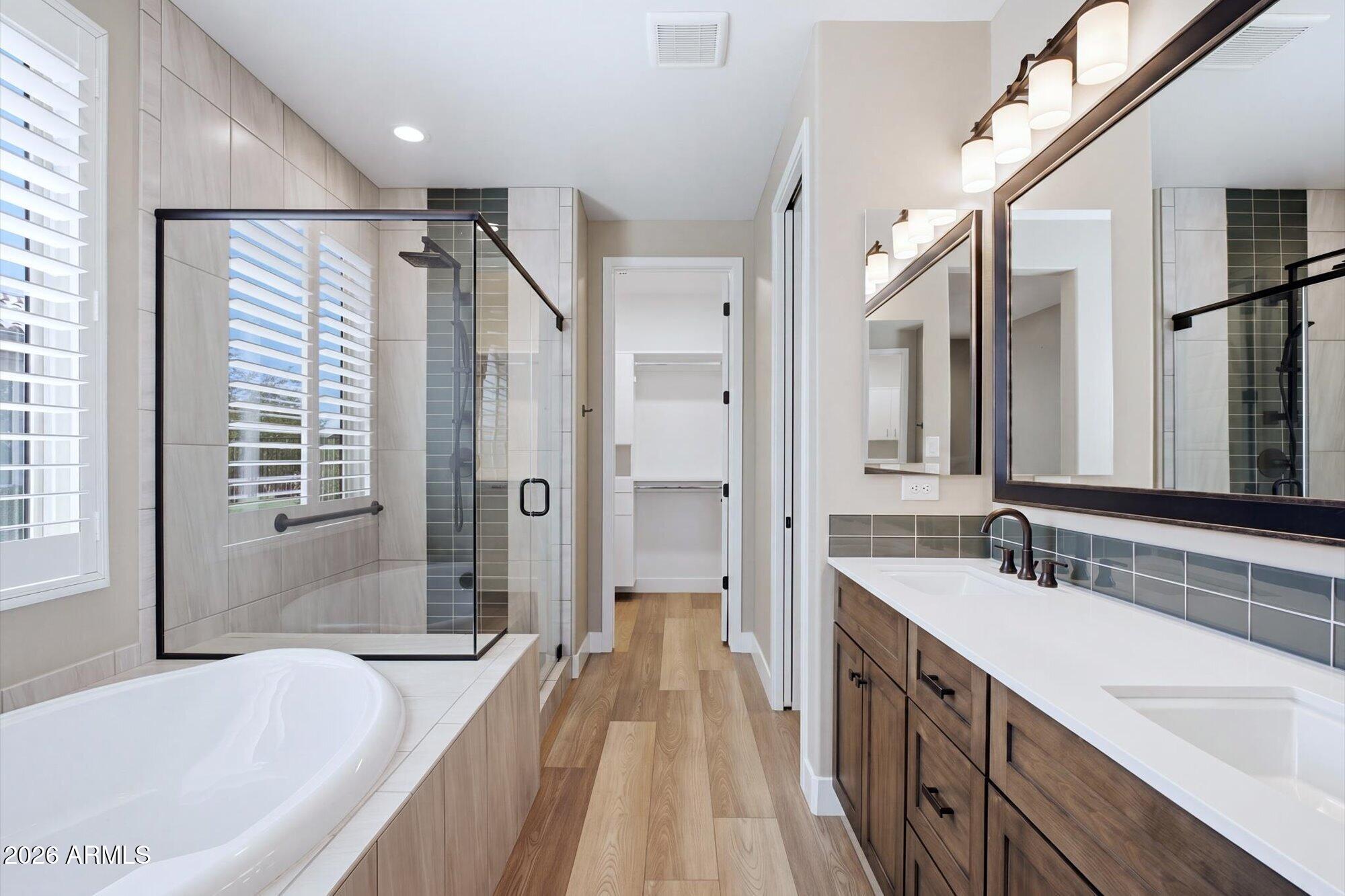 16849 West Merrell Street Goodyear, AZ 85395 - Photo 18 of 35 a spacious bathroom with sink shower and a bathtub