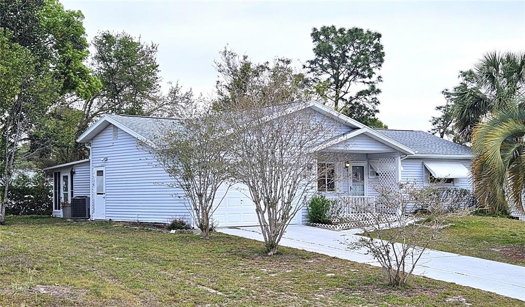 8449 Southwest 106th Place Ocala, FL 34481 - Photo 2 of 37 a front view of a house with garden