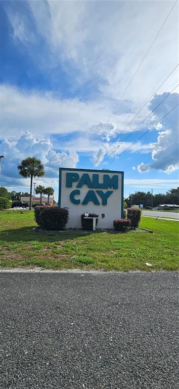 8449 Southwest 106th Place Ocala, FL 34481 - Photo 22 of 26 a front view of a house with a big yard and a large tree