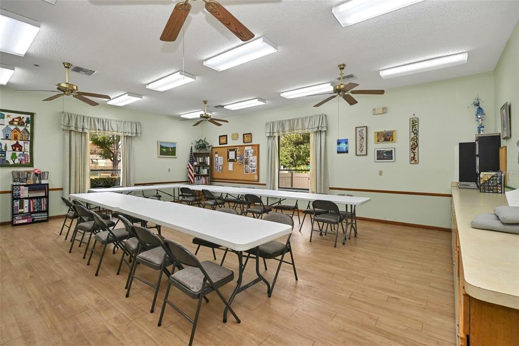 8449 Southwest 106th Place Ocala, FL 34481 - Photo 32 of 37 a view of a dining room with furniture and wooden floor
