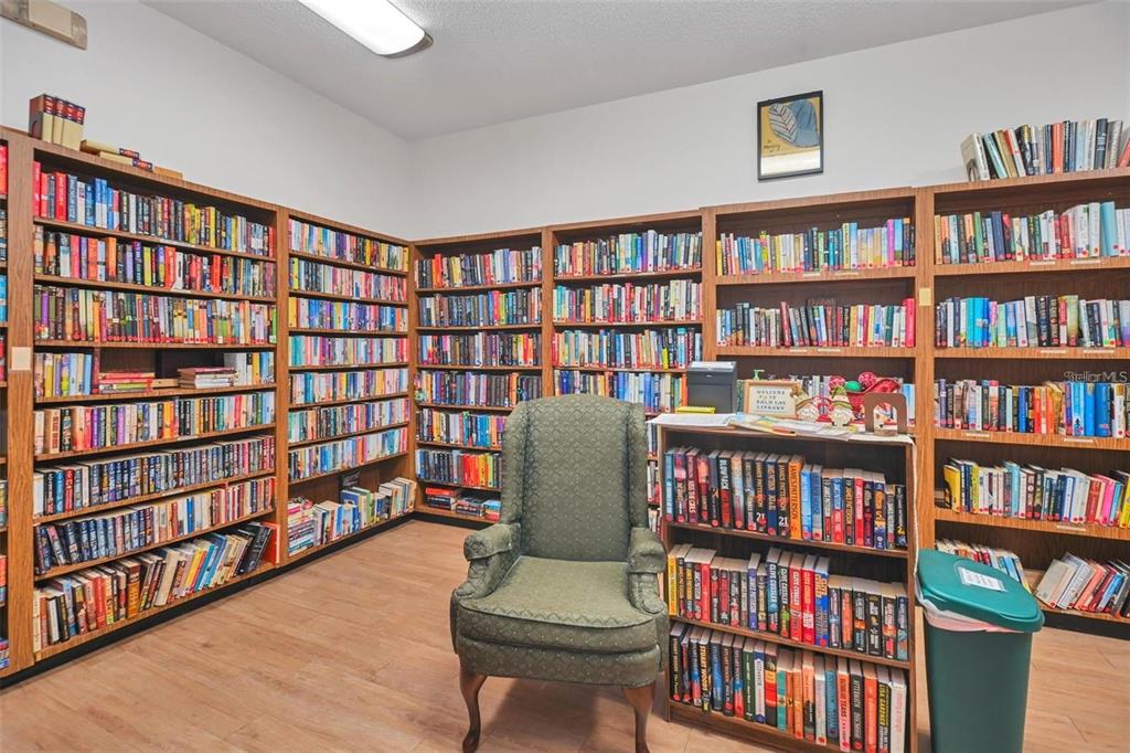8449 Southwest 106th Place Ocala, FL 34481 - Photo 33 of 37 a living room with a book shelf and a book shelf