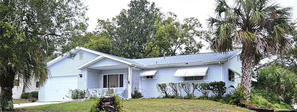 8449 Southwest 106th Place Ocala, FL 34481 - Photo 4 of 37 a view of a house with a yard
