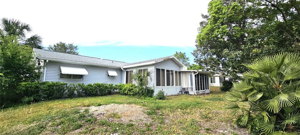 8449 Southwest 106th Place Ocala, FL 34481 - Photo 6 of 37 a front view of a house with garden