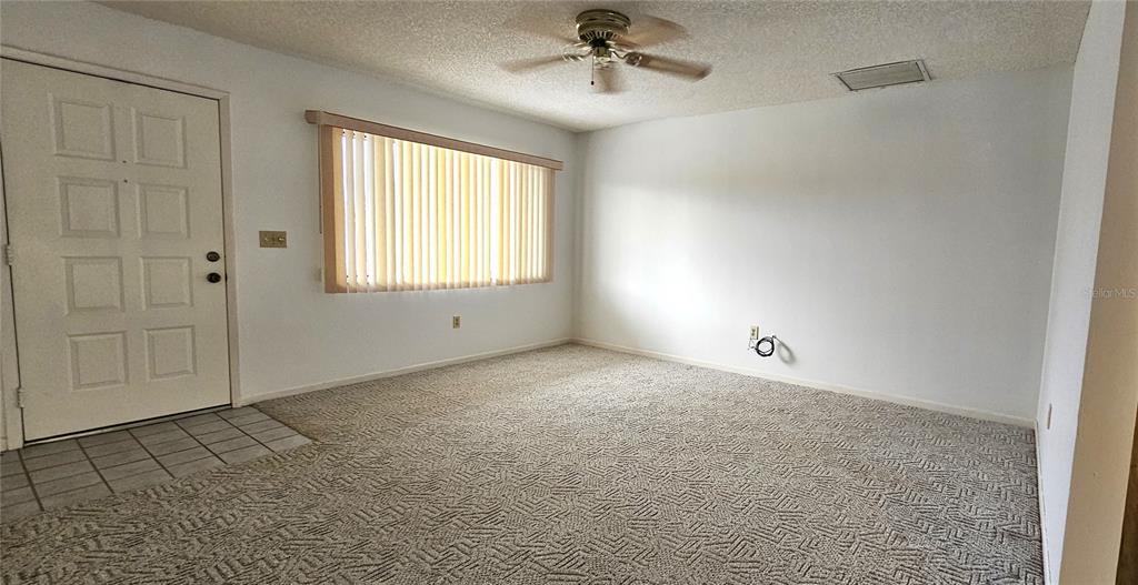 8449 Southwest 106th Place Ocala, FL 34481 - Photo 8 of 26 a view of an empty room with a window