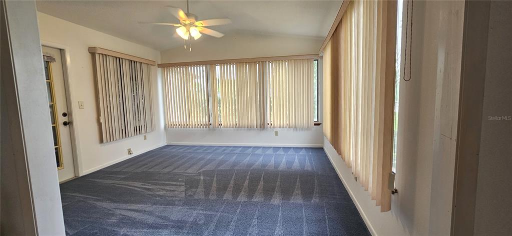 8449 Southwest 106th Place Ocala, FL 34481 - Photo 9 of 26 a view of an empty room with wooden floor and a window