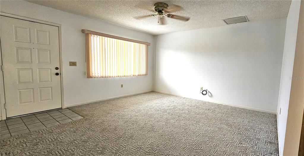 8449 Southwest 106th Place Ocala, FL 34481 - Photo 10 of 37 a view of an empty room with a window