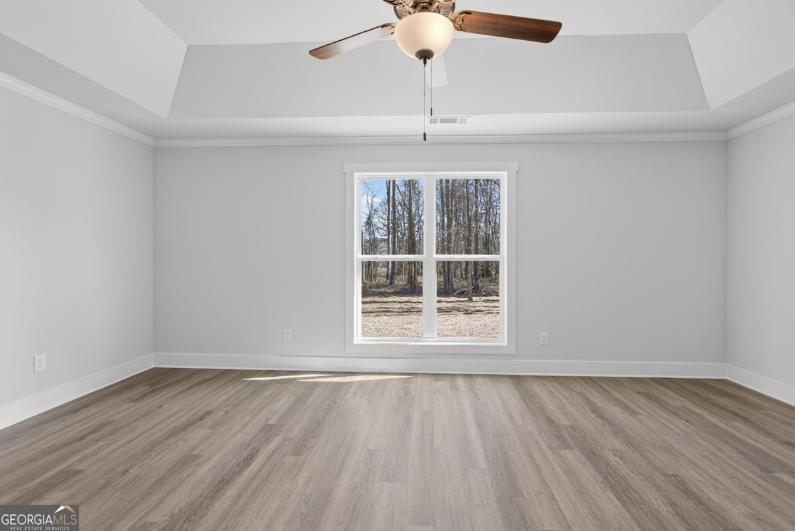 198 Mockingbird Lane, Unit 30 Winder, GA 30680 - Photo 29 of 39 wooden floor in an empty room with a window