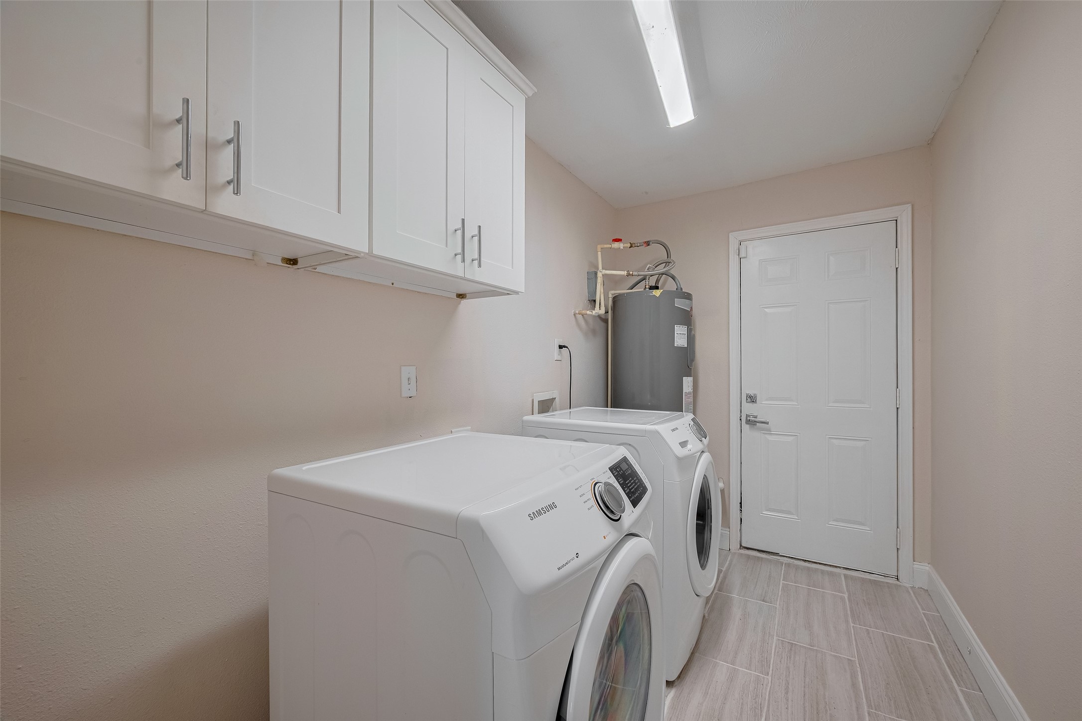 3930 Daphne Street Houston, TX 77021 - Photo 24 of 44 Tucked neatly away, the laundry room is both functional and polished, with upper cabinetry for storage and lighting that keeps things bright and efficient.