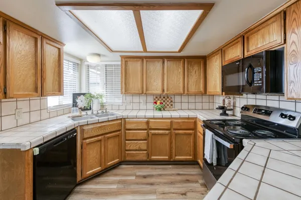 a kitchen with stainless steel appliances granite countertop a sink stove and cabinets