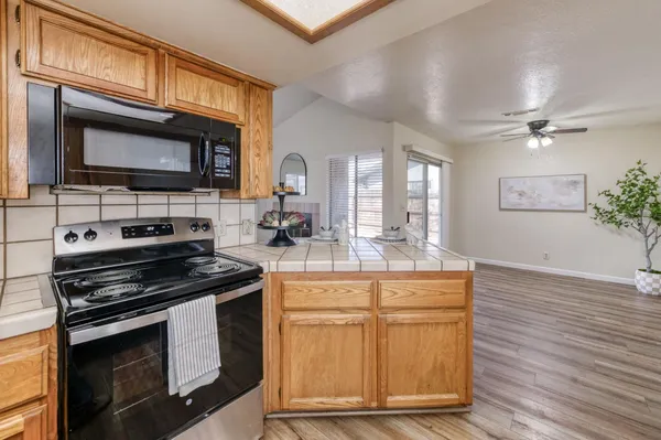 a kitchen with stainless steel appliances granite countertop a stove microwave and cabinets