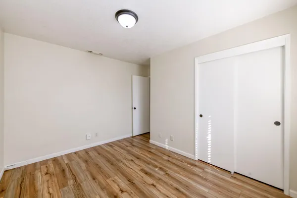 a view of a room with wooden floor