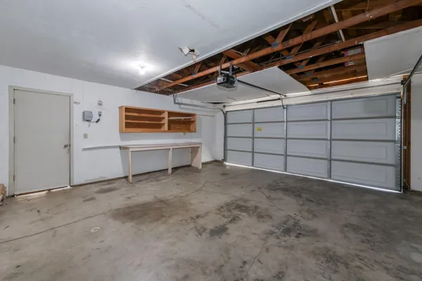 a view of a house with backyard and a tree
