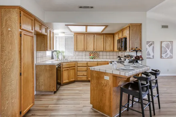 a kitchen with a sink stove and cabinets