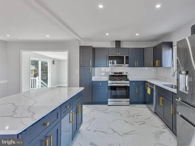 a kitchen with stainless steel appliances granite countertop a stove top oven a sink and dishwasher