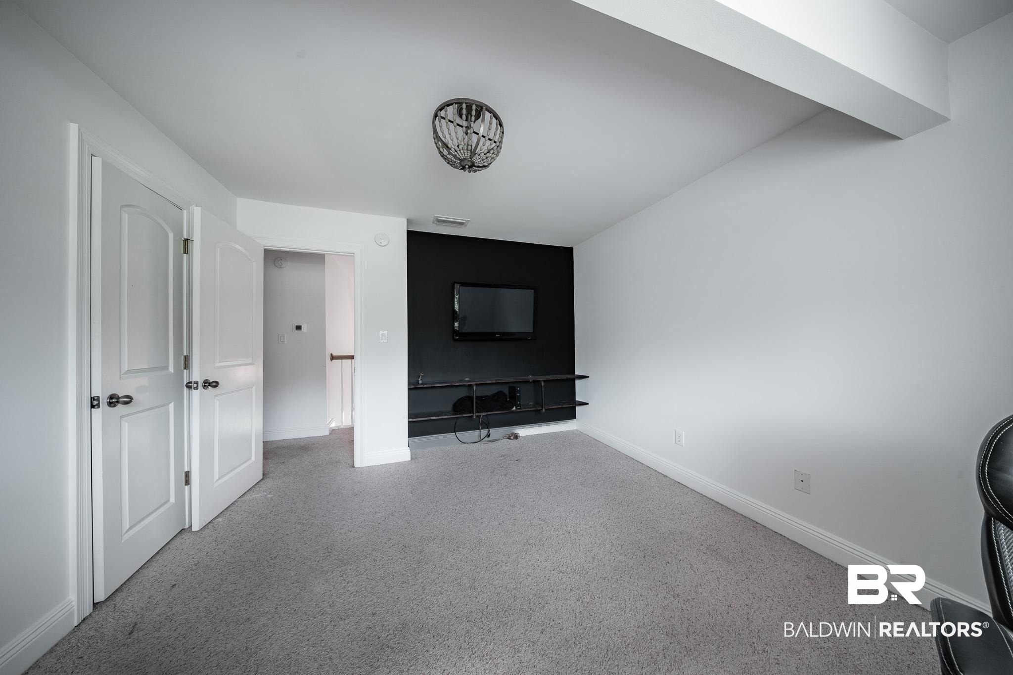 8421 Weatherford Court Daphne, AL 36527 - Photo 27 of 36 Carpeted living area featuring baseboards