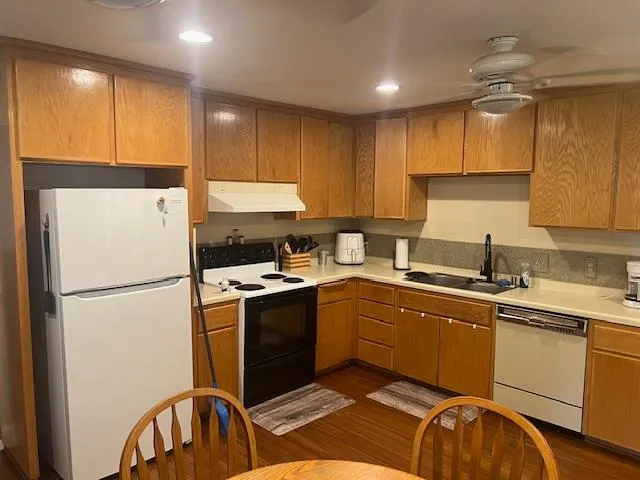 a kitchen with a sink a stove and refrigerator